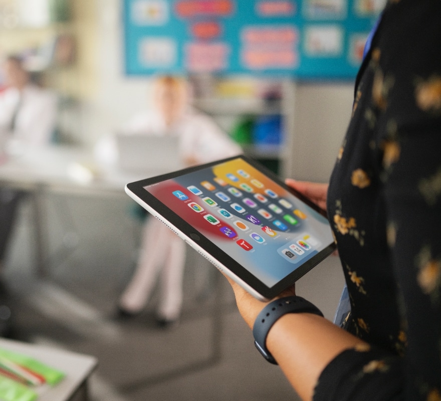 Teacher with iPad in front of class