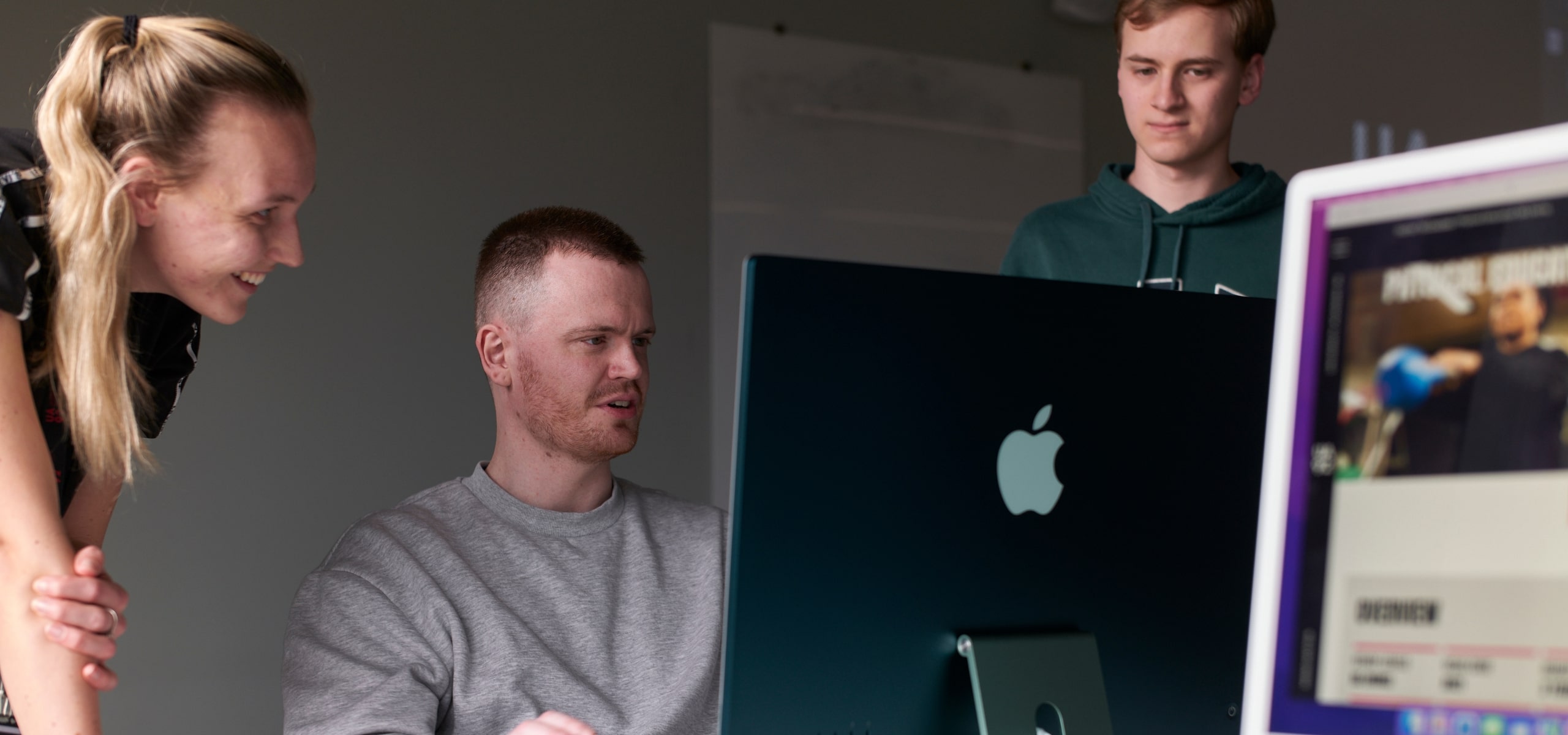 Office workers collaborating on iMac