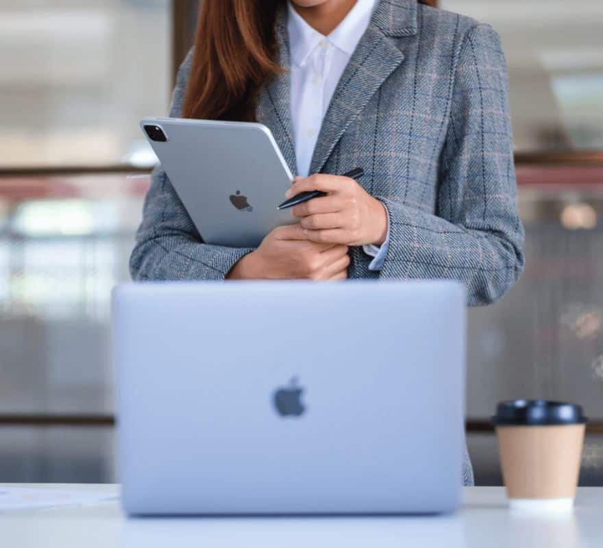 A Government worker using a range of Apple devices to complete their work.