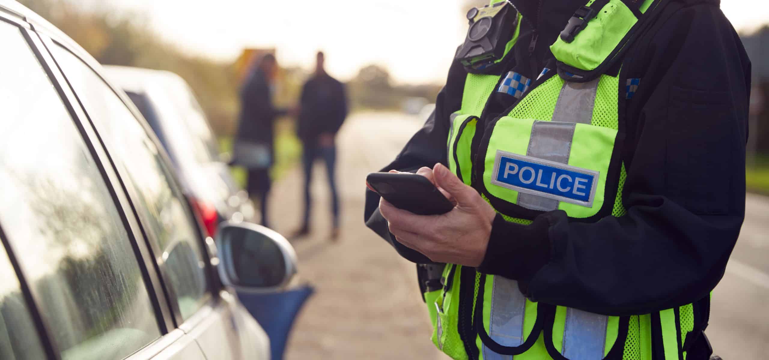 A police officer using an iPhone to file a report in the field.